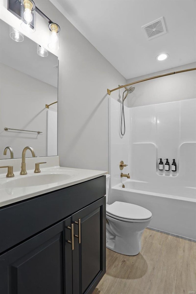 full bathroom featuring vanity,  shower combination, toilet, and wood-type flooring