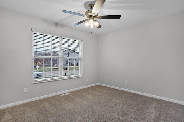 spare room featuring carpet and ceiling fan