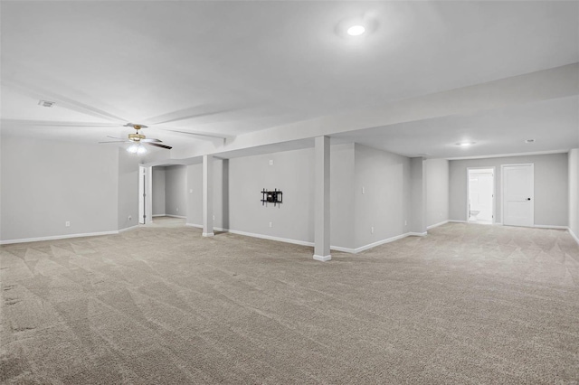 basement with ceiling fan and light carpet