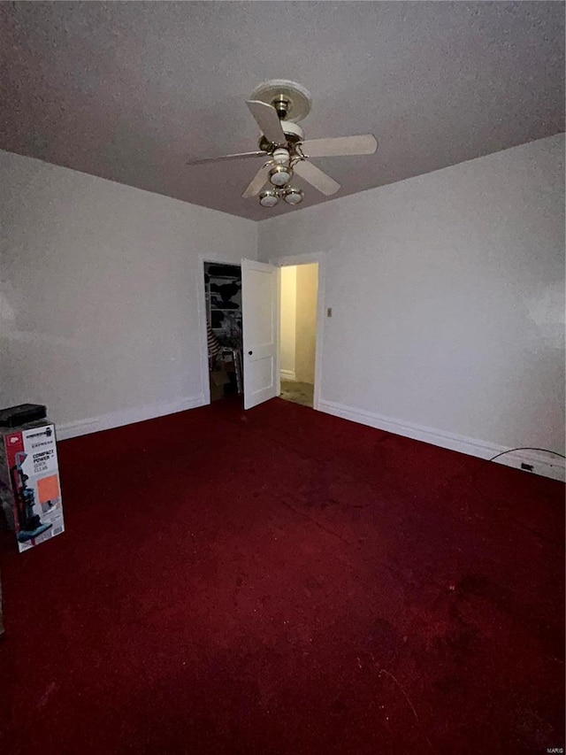 interior space with ceiling fan, carpet, and a textured ceiling