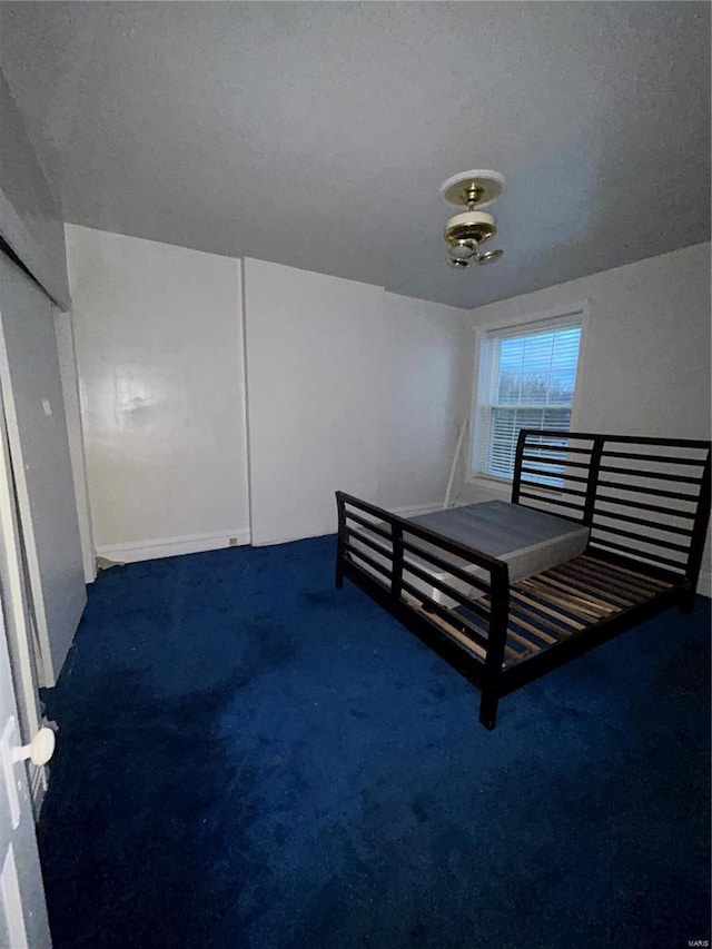 unfurnished bedroom featuring dark colored carpet