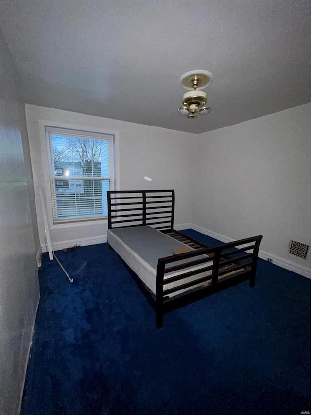 bedroom featuring dark carpet