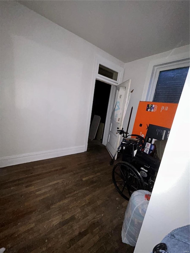 bedroom with dark wood-type flooring