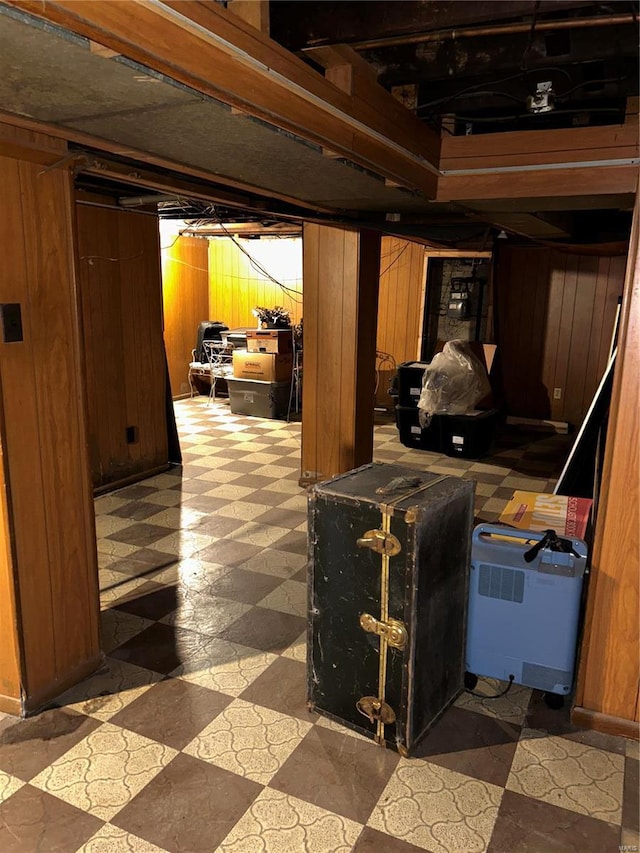 basement featuring wooden walls