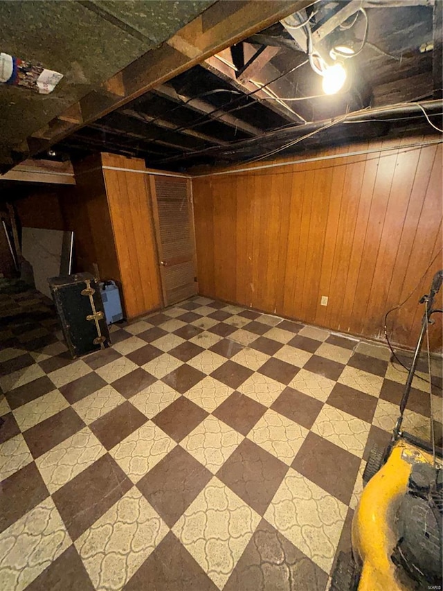 basement featuring wood walls