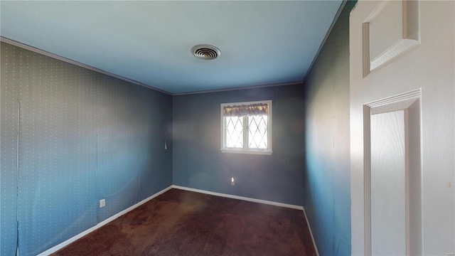 spare room with dark carpet and ornamental molding