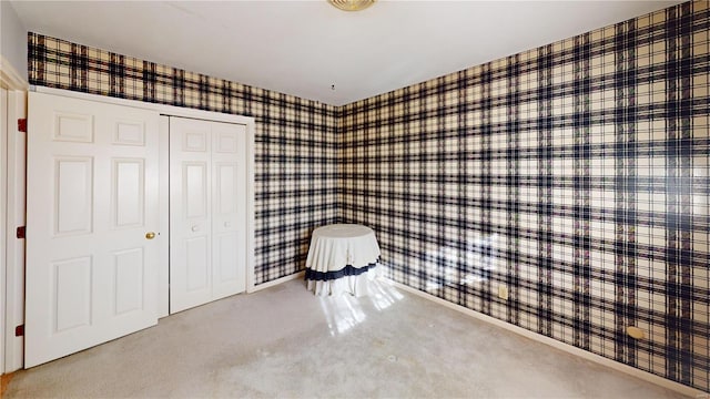 unfurnished bedroom featuring carpet and a closet