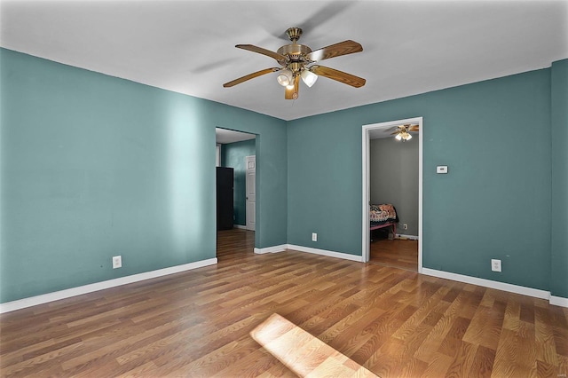 unfurnished room with hardwood / wood-style floors and ceiling fan