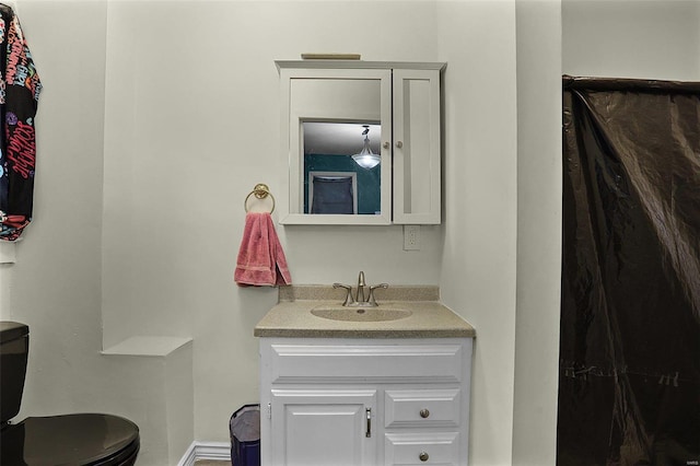 bathroom featuring vanity and toilet