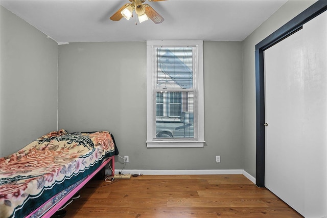 bedroom with ceiling fan and hardwood / wood-style floors