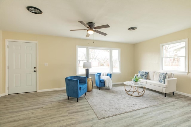 sitting room with light hardwood / wood-style flooring and ceiling fan