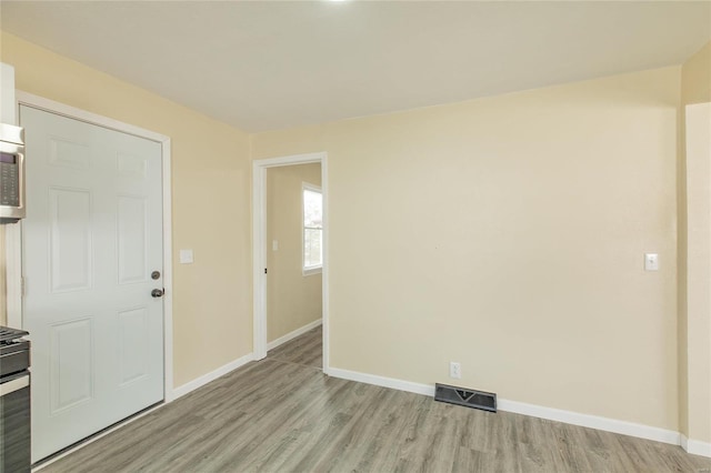 spare room featuring light hardwood / wood-style floors