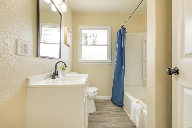 full bathroom with vanity, hardwood / wood-style flooring, toilet, and shower / tub combo with curtain