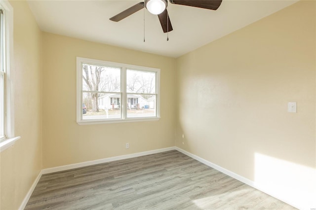 empty room featuring ceiling fan and light hardwood / wood-style flooring