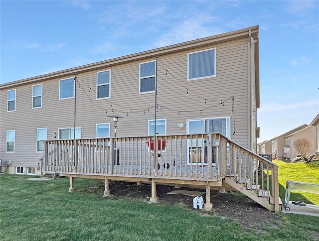 rear view of property with a yard and a wooden deck