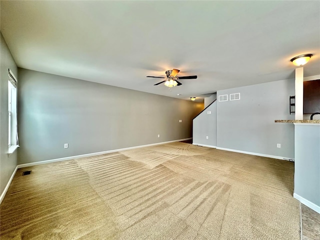 spare room featuring carpet floors and ceiling fan