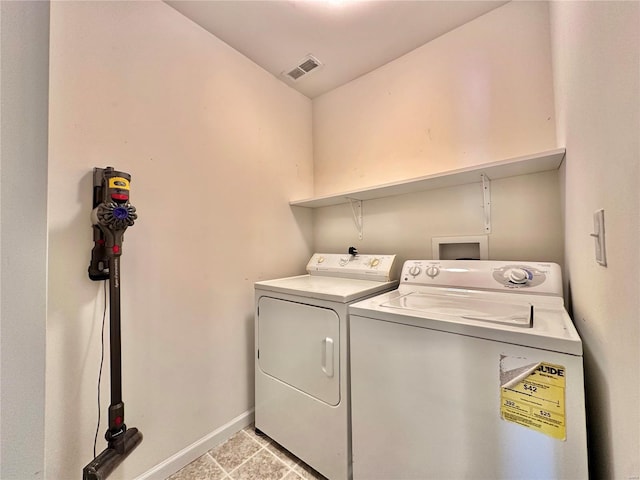 washroom with independent washer and dryer