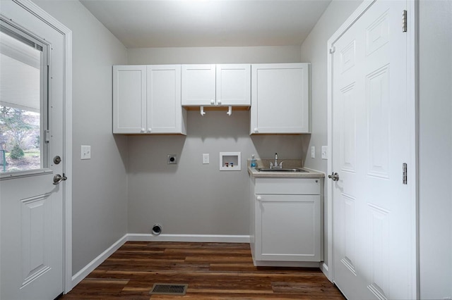 laundry area featuring sink, cabinets, hookup for a washing machine, dark wood-type flooring, and hookup for an electric dryer