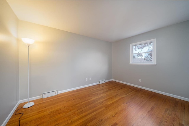 spare room featuring hardwood / wood-style flooring