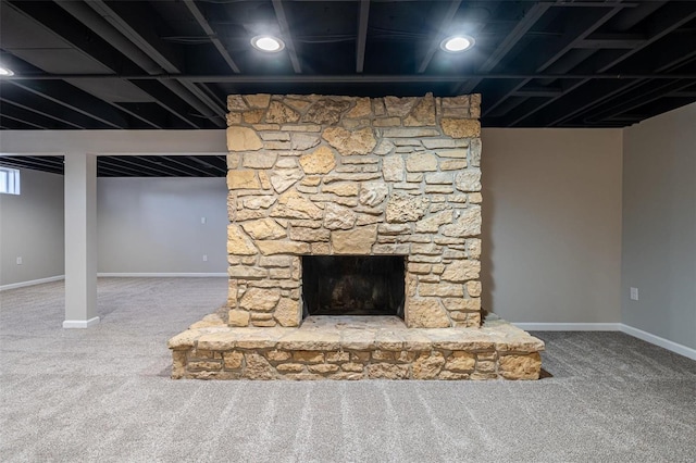 interior space featuring a stone fireplace and carpet floors