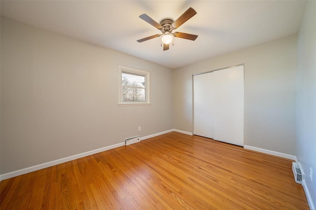 unfurnished bedroom featuring a closet, ceiling fan, and light wood-type flooring