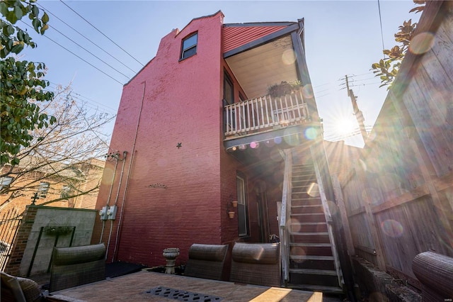 view of side of home featuring a balcony