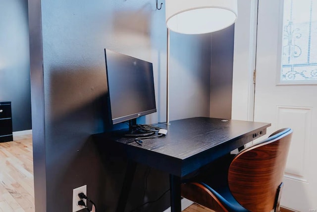 office area with light hardwood / wood-style floors