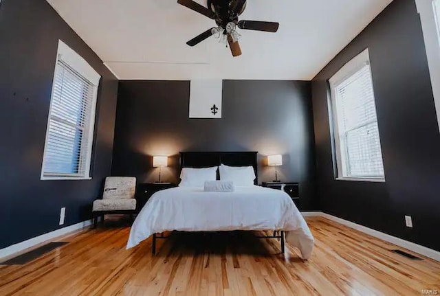 bedroom with ceiling fan and light hardwood / wood-style flooring