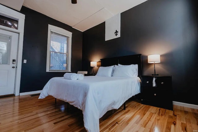 bedroom with ceiling fan and wood-type flooring