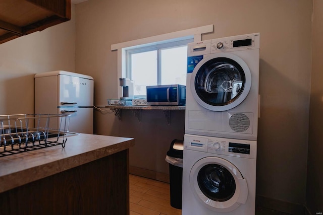 laundry room with stacked washer and clothes dryer