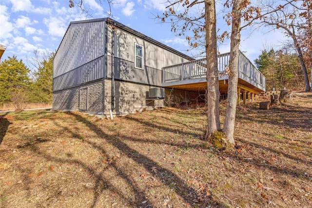 rear view of property featuring a deck