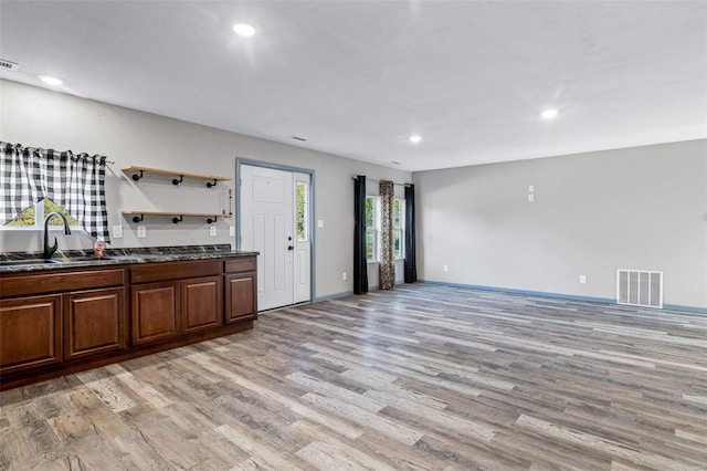 kitchen with sink and light hardwood / wood-style flooring