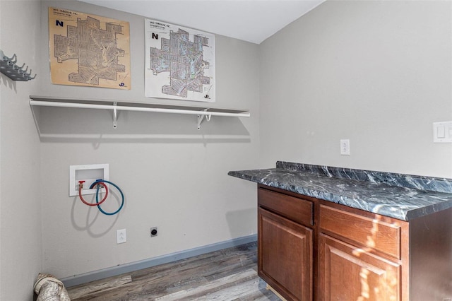 laundry room featuring electric dryer hookup, cabinets, washer hookup, and light hardwood / wood-style floors