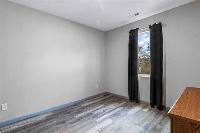 unfurnished room with light wood-type flooring