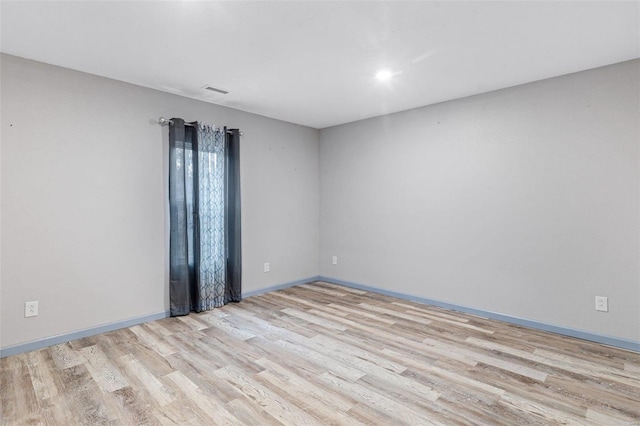 unfurnished room featuring light hardwood / wood-style floors