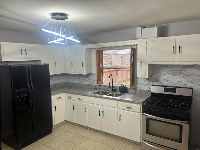 kitchen featuring sink, gas range, light tile patterned floors, black fridge with ice dispenser, and white cabinetry