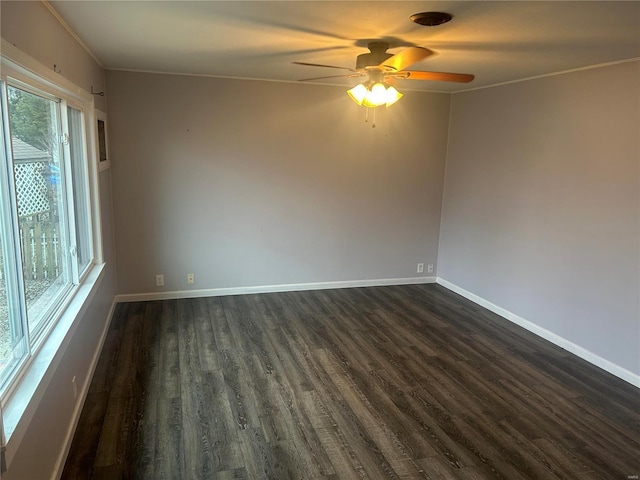 spare room featuring ceiling fan, dark hardwood / wood-style flooring, and crown molding