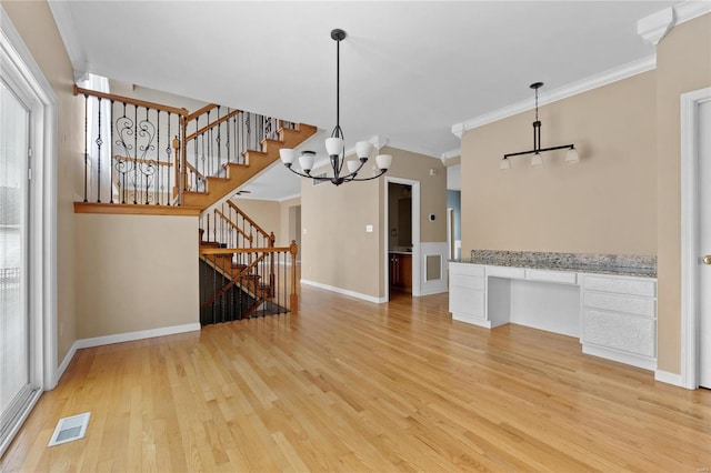 interior space with light hardwood / wood-style flooring, a chandelier, and ornamental molding