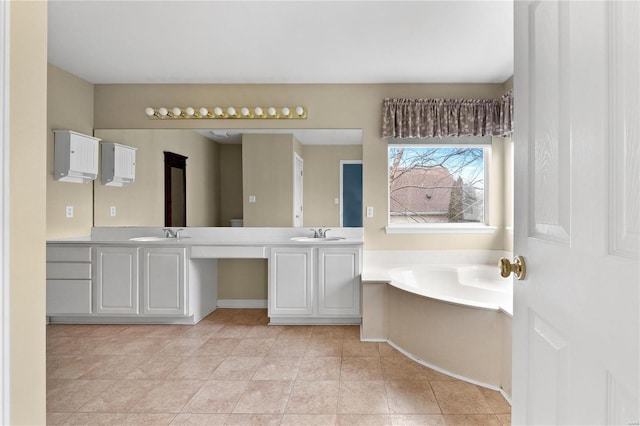 bathroom featuring tile patterned floors, a washtub, and vanity