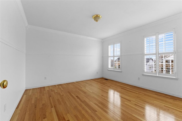 unfurnished room featuring light wood-type flooring and crown molding