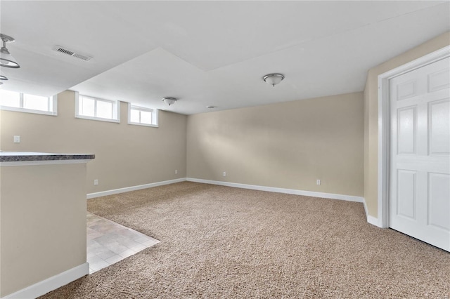 basement featuring carpet floors and a wealth of natural light