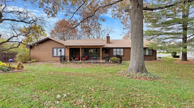 rear view of house featuring a lawn and a patio