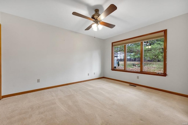 carpeted empty room featuring ceiling fan