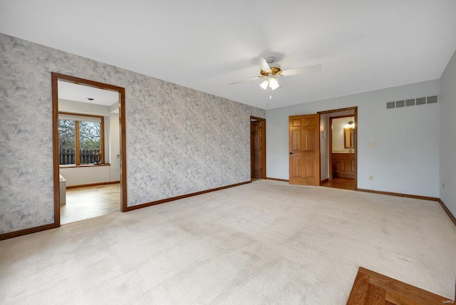 spare room featuring carpet and ceiling fan