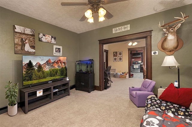 carpeted living room with ceiling fan and a textured ceiling