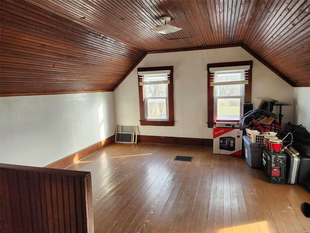 additional living space with wood-type flooring, vaulted ceiling, and wood ceiling