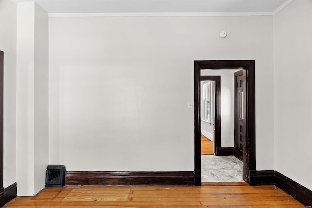 unfurnished room featuring hardwood / wood-style floors and crown molding