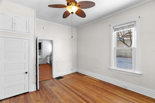 unfurnished bedroom featuring wood-type flooring, ceiling fan, and crown molding