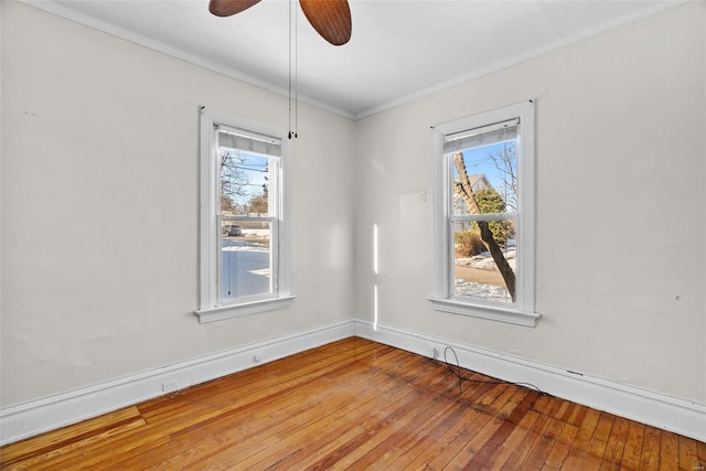 empty room with ceiling fan, ornamental molding, and wood-type flooring