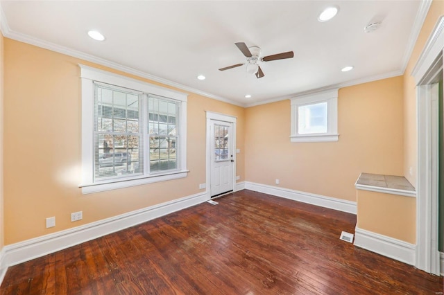 spare room with dark hardwood / wood-style floors, ceiling fan, and ornamental molding